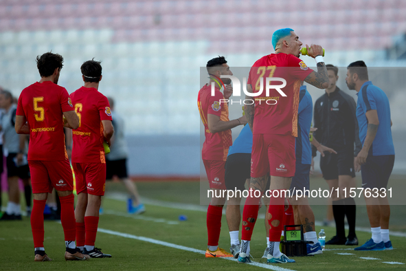 Birkirkara soccer players refresh themselves during a cooling break at the Malta 360 Sports Premier League soccer match between Hibernians a...