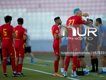 Birkirkara soccer players refresh themselves during a cooling break at the Malta 360 Sports Premier League soccer match between Hibernians a...