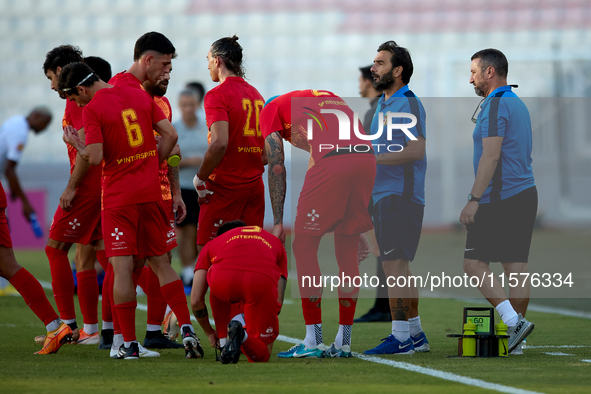 Stefano De Angelis, head coach of Birkirkara, speaks to his players during a cooling break at the Malta 360 Sports Premier League soccer mat...