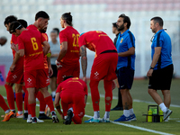 Stefano De Angelis, head coach of Birkirkara, speaks to his players during a cooling break at the Malta 360 Sports Premier League soccer mat...