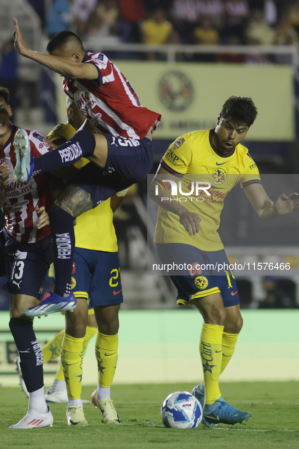 Roberto Alvarado #25 of Chivas de Guadalajara and Nestor Araujo #14 of America during the 17th round match of the Torneo de Apertura as part...