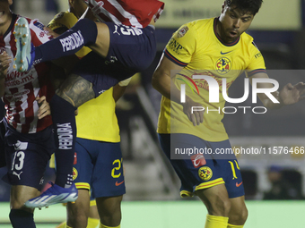 Roberto Alvarado #25 of Chivas de Guadalajara and Nestor Araujo #14 of America during the 17th round match of the Torneo de Apertura as part...