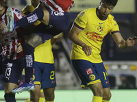 Roberto Alvarado #25 of Chivas de Guadalajara and Nestor Araujo #14 of America during the 17th round match of the Torneo de Apertura as part...