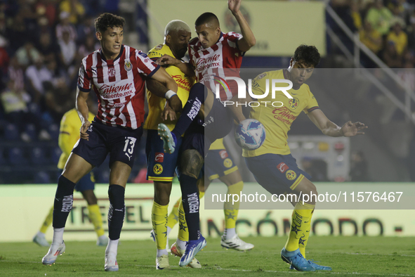 Roberto Alvarado #25 of Chivas de Guadalajara and Nestor Araujo #14 of America during the 17th round match of the Torneo de Apertura as part...