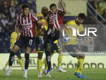 Roberto Alvarado #25 of Chivas de Guadalajara and Nestor Araujo #14 of America during the 17th round match of the Torneo de Apertura as part...