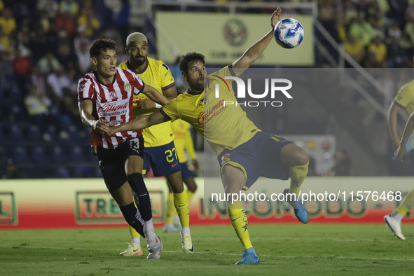 Jesus Orozco #13 of Chivas de Guadalajara and Nestor Araujo #14 of America during the 17th round match of the Torneo de Apertura as part of...