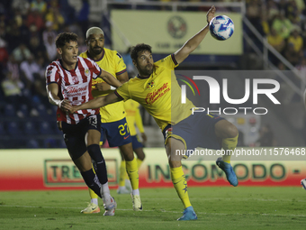 Jesus Orozco #13 of Chivas de Guadalajara and Nestor Araujo #14 of America during the 17th round match of the Torneo de Apertura as part of...