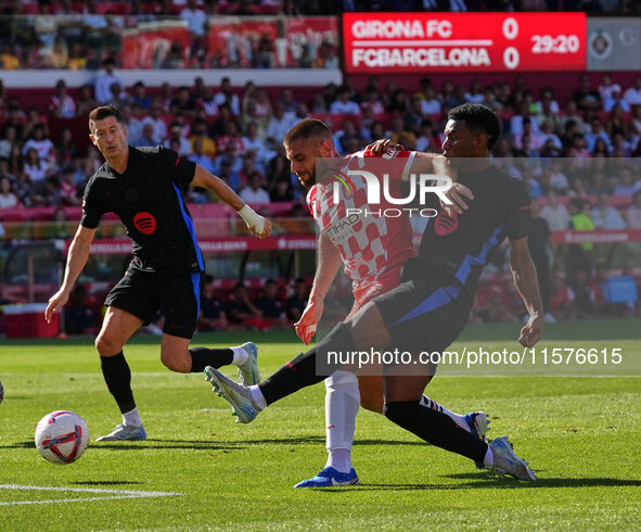 David Lopez of Girona clears the ball from danger during the La Liga EA SPORTS match against FC Barcelona at Estadi Montilivi in Girona, Spa...