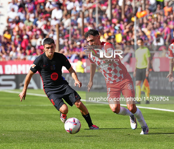 Ivan Martin of Girona challenges Pedri of FC Barcelona for possession during the La Liga EA SPORTS match at Estadi Montilivi in Girona, Spai...