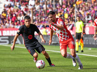 Ivan Martin of Girona challenges Pedri of FC Barcelona for possession during the La Liga EA SPORTS match at Estadi Montilivi in Girona, Spai...