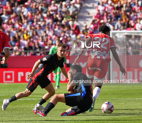 Jhon Solis of Girona challenges Pedri of FC Barcelona for possession during the La Liga EA SPORTS match at Estadi Montilivi in Girona, Spain...