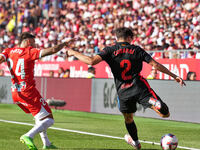 Portu of Girona challenges Pau Cubarsi of FC Barcelona for possession during the La Liga EA SPORTS match at Estadi Montilivi in Girona, Spai...