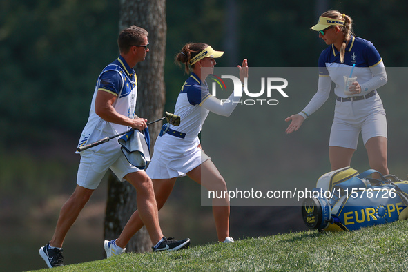 GAINESVILLE, VIRGINIA - SEPTEMBER 15: Linn Grant of Team Europe celebrates her putt on hole 11 while walking with her caddie during the fina...