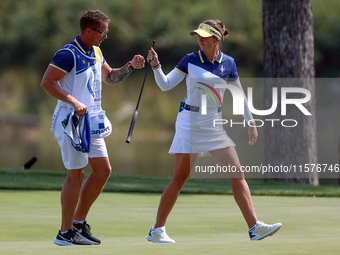 GAINESVILLE, VIRGINIA - SEPTEMBER 15: Linn Grant of Team Europe celebrates her putt on hole 11 with her caddie during the final round of the...