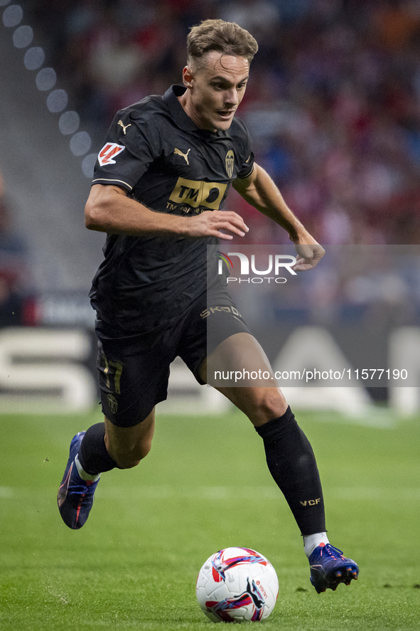 Dani Gomez of Valencia CF is in action with the ball during the La Liga EA Sports 2024/25 football match between Atletico Madrid and Valenci...