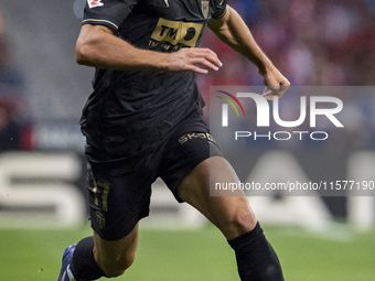 Dani Gomez of Valencia CF is in action with the ball during the La Liga EA Sports 2024/25 football match between Atletico Madrid and Valenci...