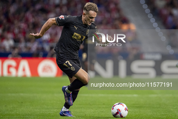 Dani Gomez of Valencia CF is in action with the ball during the La Liga EA Sports 2024/25 football match between Atletico Madrid and Valenci...