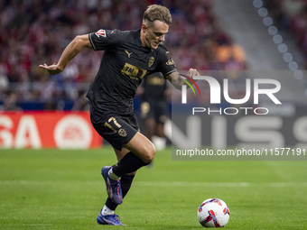 Dani Gomez of Valencia CF is in action with the ball during the La Liga EA Sports 2024/25 football match between Atletico Madrid and Valenci...