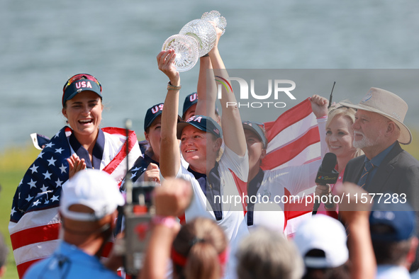 GAINESVILLE, VIRGINIA - SEPTEMBER 15: Captain Stacy Lewis of the United States holds up the trophy after winning the Solheim Cup at Robert T...