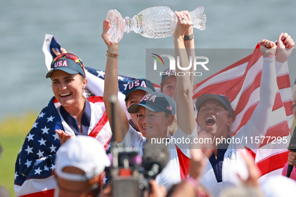 GAINESVILLE, VIRGINIA - SEPTEMBER 15: Captain Stacy Lewis of the United States holds up the trophy after winning the Solheim Cup at Robert T...