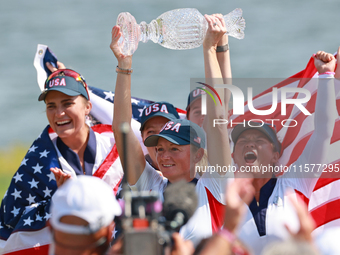 GAINESVILLE, VIRGINIA - SEPTEMBER 15: Captain Stacy Lewis of the United States holds up the trophy after winning the Solheim Cup at Robert T...