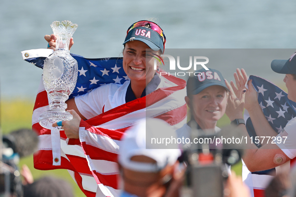 GAINESVILLE, VIRGINIA - SEPTEMBER 15: Lexi Thompson of the United States holds up the trophy after winning the Solheim Cup at Robert Trent J...