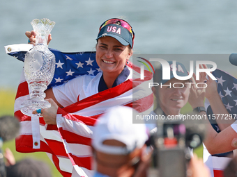 GAINESVILLE, VIRGINIA - SEPTEMBER 15: Lexi Thompson of the United States holds up the trophy after winning the Solheim Cup at Robert Trent J...