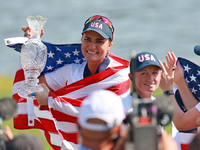 GAINESVILLE, VIRGINIA - SEPTEMBER 15: Lexi Thompson of the United States holds up the trophy after winning the Solheim Cup at Robert Trent J...