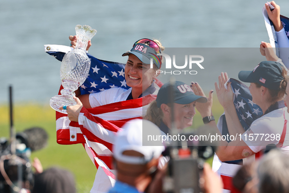 GAINESVILLE, VIRGINIA - SEPTEMBER 15: Lexi Thompson of the United States holds up the trophy after winning the Solheim Cup at Robert Trent J...