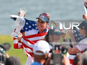 GAINESVILLE, VIRGINIA - SEPTEMBER 15: Lexi Thompson of the United States holds up the trophy after winning the Solheim Cup at Robert Trent J...