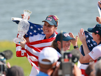 GAINESVILLE, VIRGINIA - SEPTEMBER 15: Lexi Thompson of the United States holds up the trophy after winning the Solheim Cup at Robert Trent J...