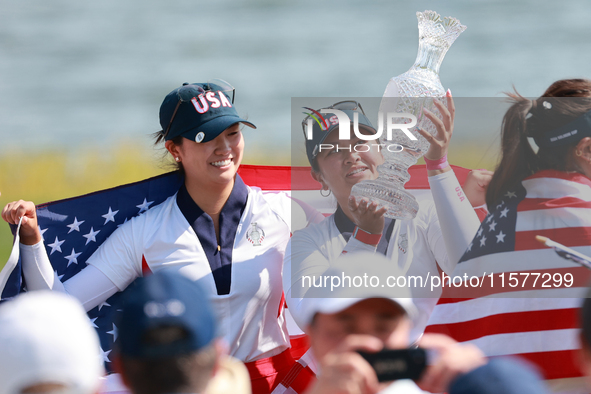 GAINESVILLE, VIRGINIA - SEPTEMBER 15: Lilia Vu of Team USA holds up the trophy after winning the Solheim Cup at Robert Trent Jones Golf Club...