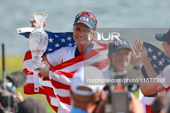 GAINESVILLE, VIRGINIA - SEPTEMBER 15: Lexi Thompson of the United States holds up the trophy after winning the Solheim Cup at Robert Trent J...