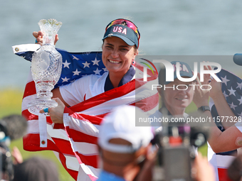 GAINESVILLE, VIRGINIA - SEPTEMBER 15: Lexi Thompson of the United States holds up the trophy after winning the Solheim Cup at Robert Trent J...