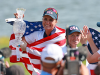 GAINESVILLE, VIRGINIA - SEPTEMBER 15: Lexi Thompson of the United States holds up the trophy after winning the Solheim Cup at Robert Trent J...