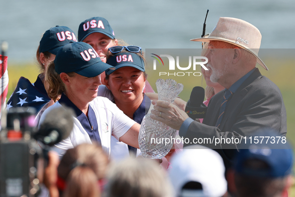 GAINESVILLE, VIRGINIA - SEPTEMBER 15: John Solheim representing the Solheim family presents Staycy Lewis of the United States with the troph...