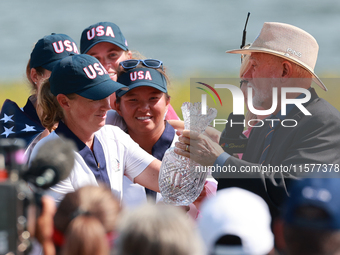 GAINESVILLE, VIRGINIA - SEPTEMBER 15: John Solheim representing the Solheim family presents Staycy Lewis of the United States with the troph...