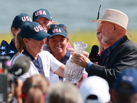 GAINESVILLE, VIRGINIA - SEPTEMBER 15: John Solheim representing the Solheim family presents Staycy Lewis of the United States with the troph...