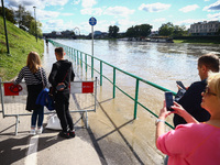 People watch a flood-wave peak after heavy rainfall  rised  the level of the Vistula River flooding a part of the boulvards in Krakow, Polan...