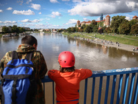 People watch a flood-wave peak after heavy rainfall  rised  the level of the Vistula River flooding a part of the boulvards in Krakow, Polan...