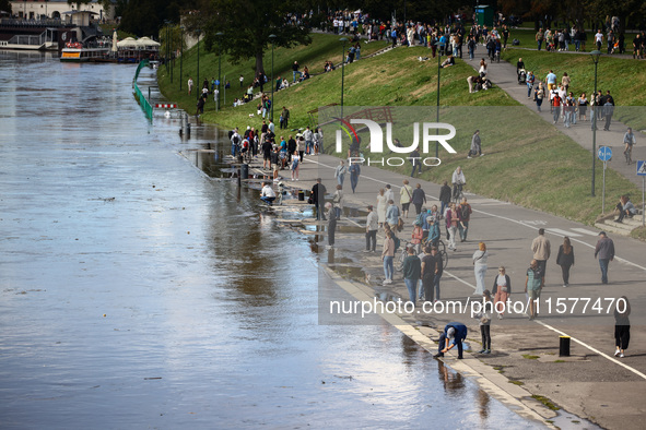 People gathered to watch flood-wave peak after heavy rainfall raised the level of the Vistula River flooding a part of the boulvards in Krak...