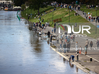 People gathered to watch flood-wave peak after heavy rainfall raised the level of the Vistula River flooding a part of the boulvards in Krak...