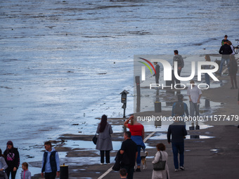 People gathered to watch flood-wave peak after heavy rainfall raised the level of the Vistula River flooding a part of the boulvards in Krak...