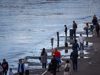 People gathered to watch flood-wave peak after heavy rainfall raised the level of the Vistula River flooding a part of the boulvards in Krak...