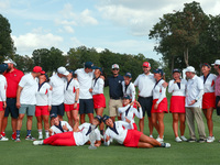 GAINESVILLE, VIRGINIA - SEPTEMBER 15: Team USA poses with their spouses and partners on the 18th green after winning the cup for the United...