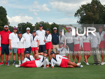 GAINESVILLE, VIRGINIA - SEPTEMBER 15: Team USA poses with their spouses and partners on the 18th green after winning the cup for the United...