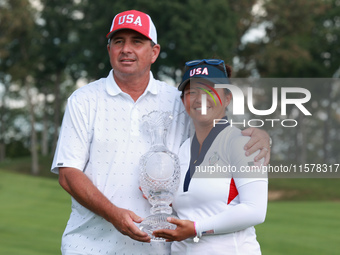 GAINESVILLE, VIRGINIA - SEPTEMBER 15: Megan Khang of the United States poses with her caddie, holding the trophy on the 18th green at the co...