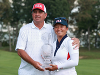 GAINESVILLE, VIRGINIA - SEPTEMBER 15: Megan Khang of the United States poses with her caddie, holding the trophy on the 18th green at the co...