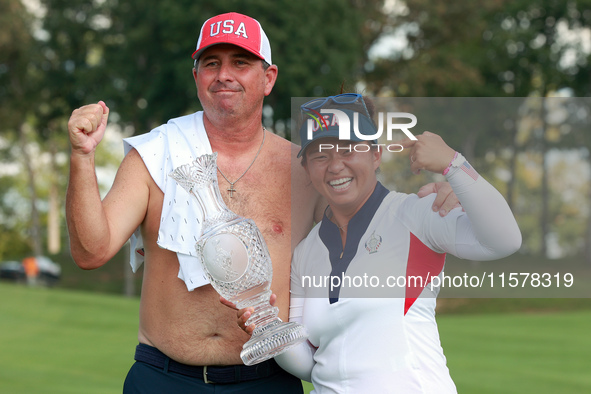 GAINESVILLE, VIRGINIA - SEPTEMBER 15: Megan Khang of the United States poses with her caddie, holding the trophy on the 18th green at the co...