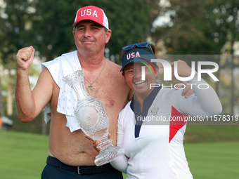 GAINESVILLE, VIRGINIA - SEPTEMBER 15: Megan Khang of the United States poses with her caddie, holding the trophy on the 18th green at the co...